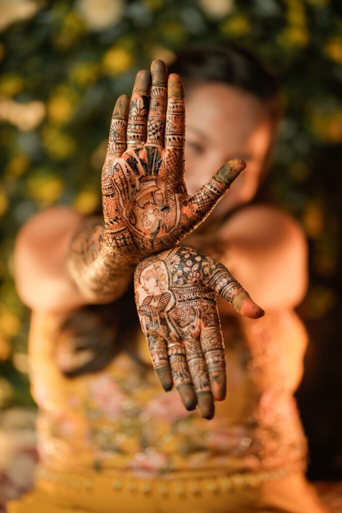 Hands decorated with detailed mehndi designs