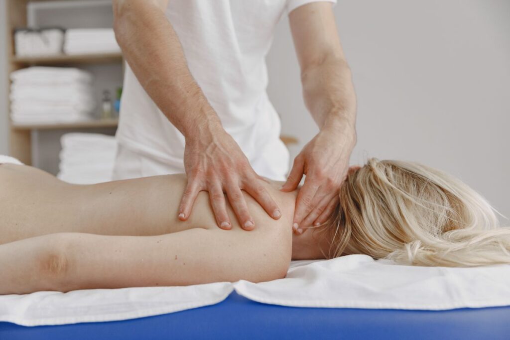 Therapist massaging a client's neck and shoulders