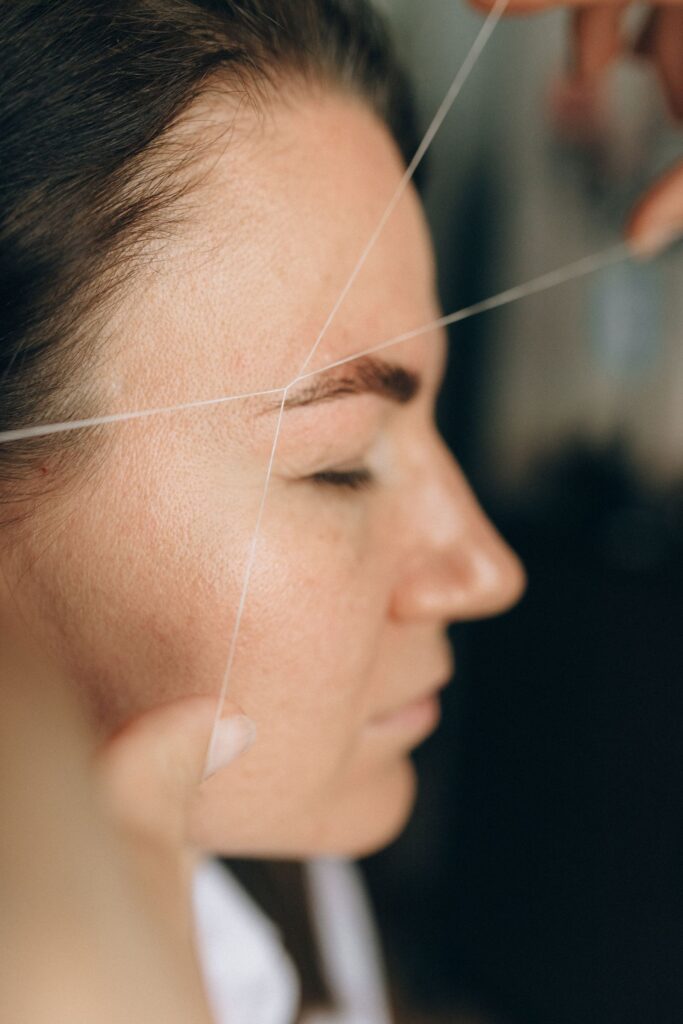 Side view of a facial threading treatment